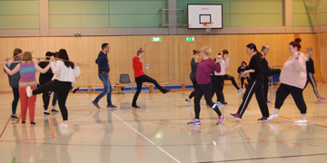 Storchenlauf mehrerer Schüler mit Stock